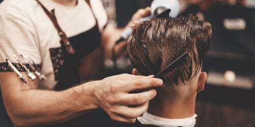 barbering combing client's hair