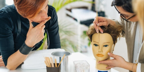 Beauty instructor demonstrating on a mannequin