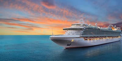 cruise ship sailing at sunset