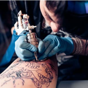 tattoo artist tattooing someone
