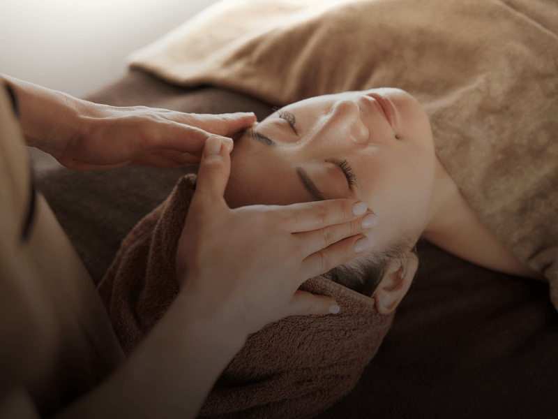 esthetician giving client a facial treatment