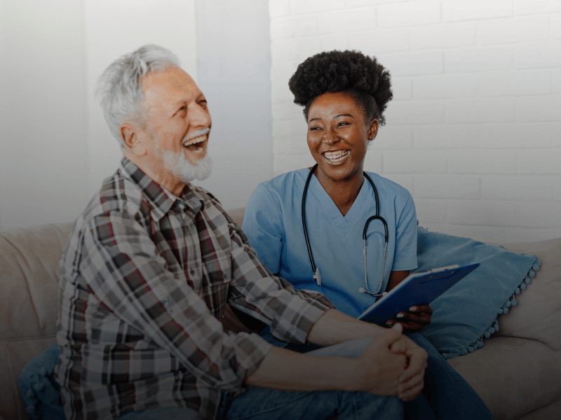 a nurse and a patient sitting on a couch